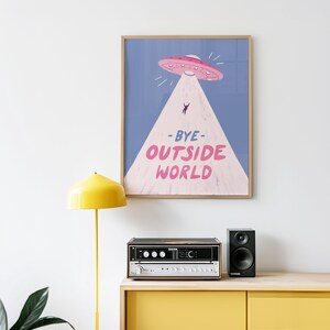 Playful blue illustration of UFO spaceship with light beam abducting stick figure. Text reads bye outside world. Perfect for homebody introvert space lovers funny modern minimalist wall decor cozy room art
