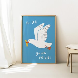 A cheeky seagull eyes a pile of fries in this vibrant, maximalist illustration, bursting with bold colors and playful text warning to protect your snacks. Perfect for adding a humorous coastal vibe to kitchens, beach house nooks, or sunny living spaces. Quirky vacation art, funny home accent, dopamine decor gift, coastal wall hanging, playful beachy print. Ideal for fry-loving friends or anyone craving a lighthearted, maximalist touch to their decor. Frame it for a pop of joy in any room.