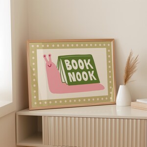 Playful pink book snail illustration with Book Nook text. Contemporary maximalist art print featuring retro-inspired design. Funky bookish wall decor, groovy library art, bibliophile gift print