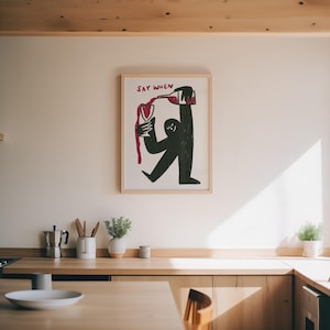 Illustration of a cute character pouring wine into a glass, wine overflowing, with hand lettered text saying when in fun typography. Perfect as kitchen wall art decoration, funny bar room decor, wine cellar artwork. Quirky illustration style with modern aesthetic, hand drawn wine art for home bar. Makes great housewarming present, wine enthusiast present, birthday gift for best friend who loves wine. Funky wine themed home decor that brings personality to kitchen, dining room, or wine room.