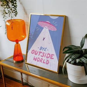 Playful blue illustration of UFO spaceship with light beam abducting stick figure. Text reads bye outside world. Perfect for homebody introvert space lovers funny modern minimalist wall decor cozy room art