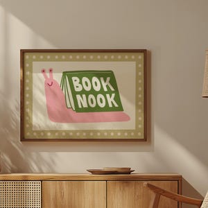 Playful pink book snail illustration with Book Nook text. Contemporary maximalist art print featuring retro-inspired design. Funky bookish wall decor, groovy library art, bibliophile gift print
