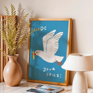 A cheeky seagull eyes a pile of fries in this vibrant, maximalist illustration, bursting with bold colors and playful text warning to protect your snacks. Perfect for adding a humorous coastal vibe to kitchens, beach house nooks, or sunny living spaces. Quirky vacation art, funny home accent, dopamine decor gift, coastal wall hanging, playful beachy print. Ideal for fry-loving friends or anyone craving a lighthearted, maximalist touch to their decor. Frame it for a pop of joy in any room.
