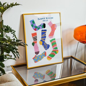 Maximalist illustration featuring a collection of vibrant patterned socks arranged in a playful composition. Perfect for maximalist decor enthusiasts, sock collectors, fashion lovers looking for unique wall art. Ideal decoration for laundry rooms, mudrooms, walk in closets, teen bedrooms, dorm rooms, or any space needing a pop of personality. Hand drawn illustration with dopamine color palette and retro inspired patterns brings quirky character to contemporary interiors.