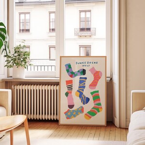 Maximalist illustration featuring a collection of vibrant patterned socks arranged in a playful composition. Perfect for maximalist decor enthusiasts, sock collectors, fashion lovers looking for unique wall art. Ideal decoration for laundry rooms, mudrooms, walk in closets, teen bedrooms, dorm rooms, or any space needing a pop of personality. Hand drawn illustration with dopamine color palette and retro inspired patterns brings quirky character to contemporary interiors.