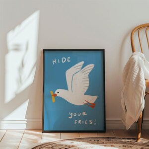 A cheeky seagull eyes a pile of fries in this vibrant, maximalist illustration, bursting with bold colors and playful text warning to protect your snacks. Perfect for adding a humorous coastal vibe to kitchens, beach house nooks, or sunny living spaces. Quirky vacation art, funny home accent, dopamine decor gift, coastal wall hanging, playful beachy print. Ideal for fry-loving friends or anyone craving a lighthearted, maximalist touch to their decor. Frame it for a pop of joy in any room.