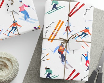 May include: White wrapping paper with a repeating pattern of skiers and ski poles. The paper is tied with twine and has a white heart-shaped tag.