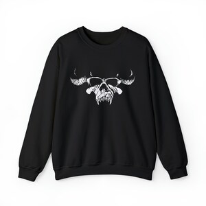 May include: Black sweatshirt with a white skull and horns graphic.