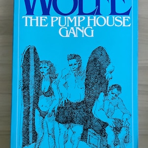 May include: A blue paperback book cover with the title "TOM WOLFE THE PUMP HOUSE GANG" in white text. The cover features a black and white illustration of four people.