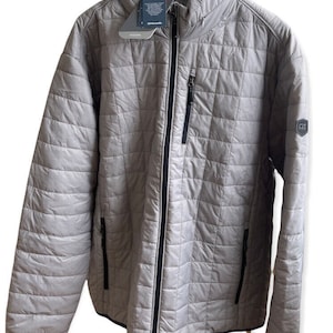 May include: A gray quilted jacket with a zipper closure and black trim. The jacket has a stand-up collar and two zippered pockets on the front. The jacket has a logo on the left sleeve that says "FZ".