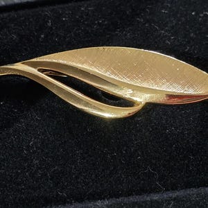 Broche vintage Napier con forma de hoja en tono dorado, bisutería firmada de estilo de mediados de siglo.