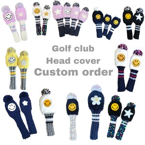 May include: Collection of knitted golf club head covers in various colors, including pink, blue, yellow, and black. Each cover features a smiley face or star design, with pom-pom accents. The text "Golf club Head cover Custom order" is also visible.