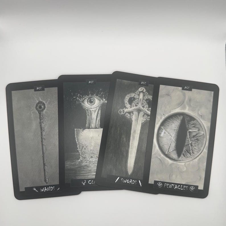 May include: Four tarot cards with black borders and grayscale illustrations. The cards feature images of a wand, an eye, a sword, and an eye within a star. The word "ACE" is at the top of each card.