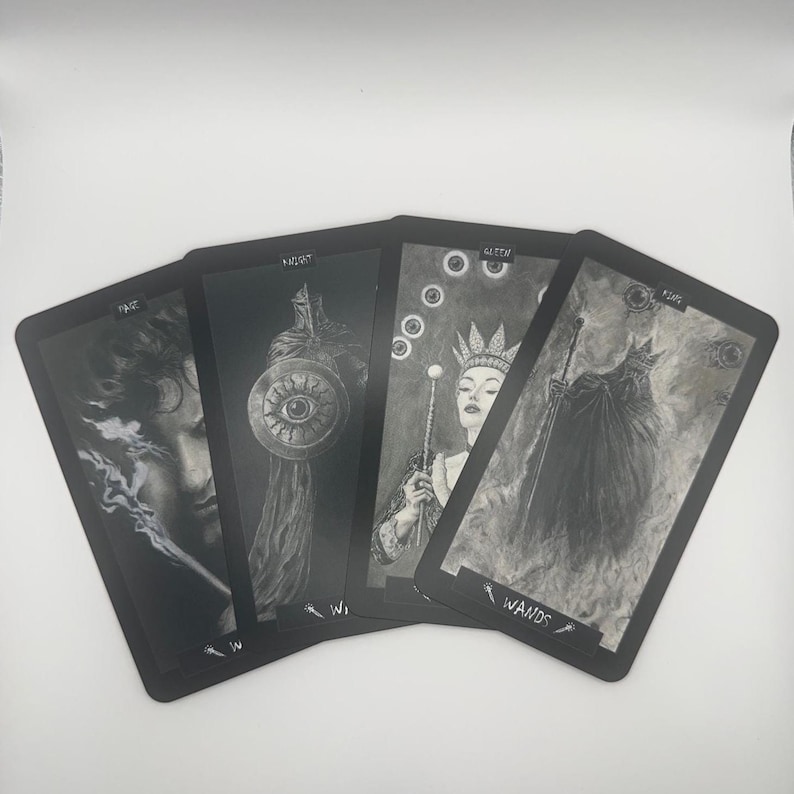May include: Four tarot cards with black borders and grayscale illustrations. The cards feature images of a person, a knight with a shield, a queen with a scepter, and a cloaked figure. The word "WANDS" is visible on one card.