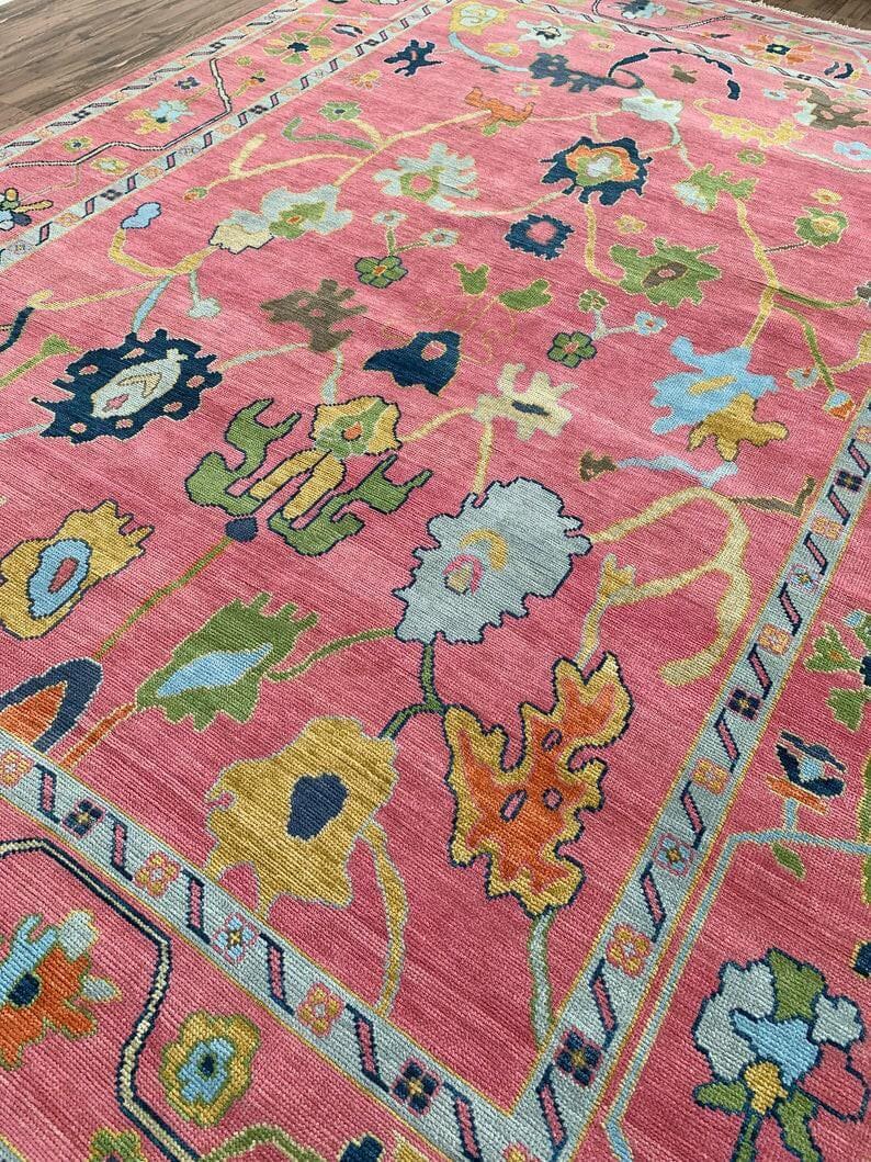 Bright pink bohemian wool rug with traditional oriental flower pattern.