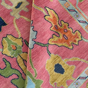Multicolor floral oriental rug on pink background, perfect boho style decor.