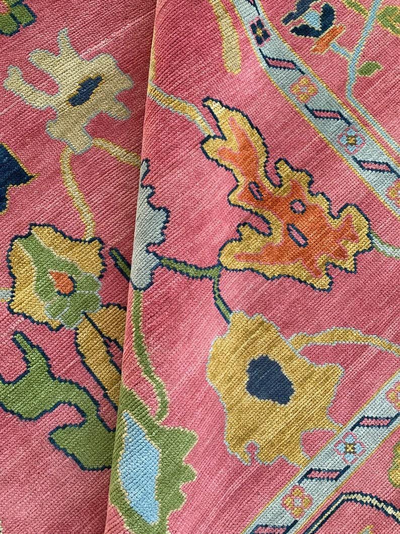 Multicolor floral oriental rug on pink background, perfect boho style decor.