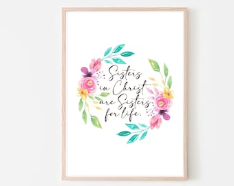 May include: A framed print with a watercolor floral wreath and the text "Sisters in Christ are Sisters for life."