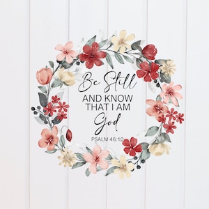 May include: A watercolour floral wreath with pink, red and yellow flowers. The wreath surrounds a quote that reads "Be Still and Know That I Am God" with the scripture reference "Psalm 46:10".