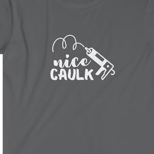 K&ouml;nnte beinhalten: Ein dunkelgraues T-Shirt mit einer wei&szlig;en Grafik einer Kartuschenpistole und dem Text "nice caulk" in einer verspielten Schrift.