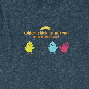 May include: A blue t-shirt with the text "Which chick is normal without permission?" and four cartoon chicks. The chicks are yellow, blue, pink, and a glittery rainbow colour.