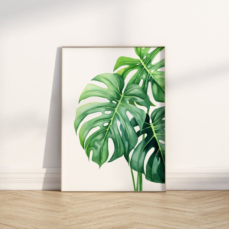 May include: A framed watercolour painting of a tropical plant with large, green leaves. The leaves have a distinctive, jagged shape and are arranged in a cluster.