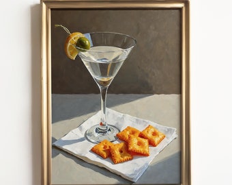 May include: A painting of a martini glass with an olive and lemon wedge, and a plate of crackers on a white napkin. The painting is framed in a gold frame.