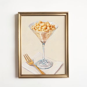 May include: Gold-framed artwork depicts a martini glass filled with macaroni and cheese, accompanied by a gold fork on a white napkin. The painting style is reminiscent of oil on canvas, with visible brushstrokes. The macaroni and cheese is a pale yellow, and the glass is clear and elegant. The overall color palette is warm and inviting, with a focus on the creamy texture of the food.