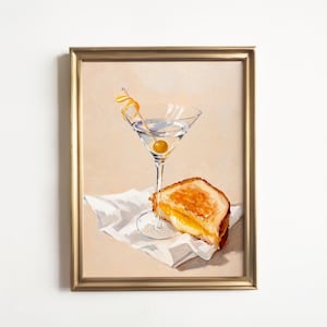 May include: A painting of a martini glass with an olive and a twist of lemon peel, and a grilled cheese sandwich on a white napkin.