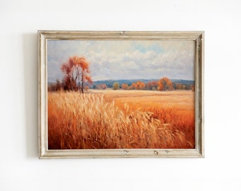 May include: A framed oil painting depicting a field of tall golden grass with a single tree in the background. The sky is a light blue with white clouds. The painting is in a rustic wooden frame.