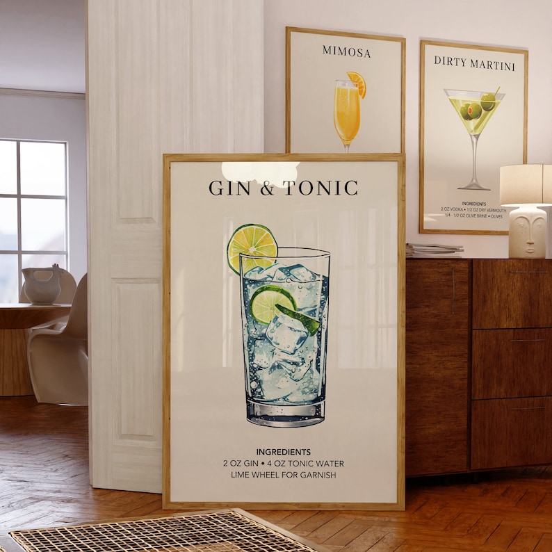 May include: A printable poster with a watercolor illustration of a gin and tonic cocktail. The poster has the title "Gin & Tonic" and lists the ingredients: 2 oz gin, 4 oz tonic water, and a lime wheel for garnish.