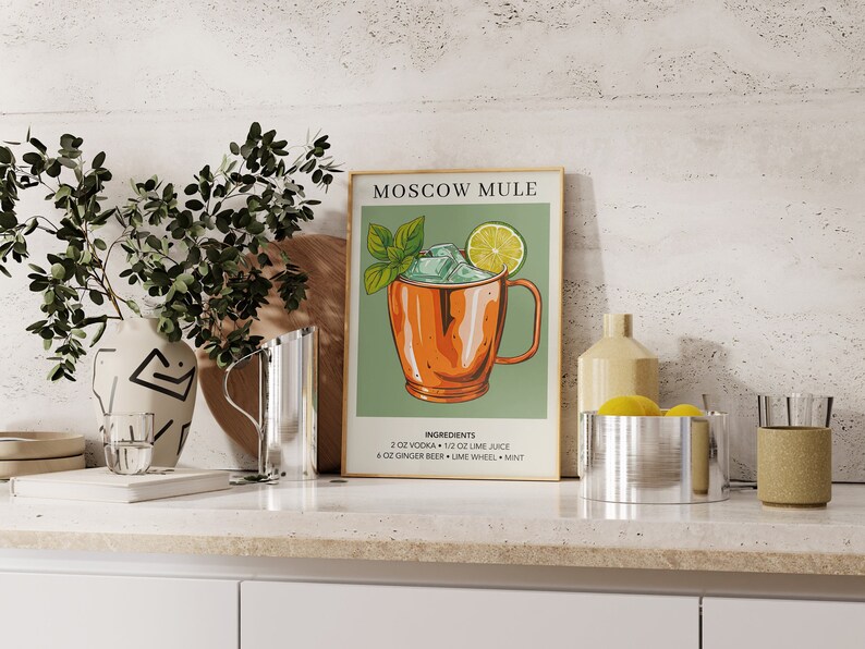 May include: A vintage-style poster with a green background and a copper mug filled with ice, a lime wedge, and a sprig of mint. The poster reads "Moscow Mule" and lists the ingredients: 2 oz vodka, 1/2 oz lime juice, 4 oz ginger beer, lime wheel, and mint.