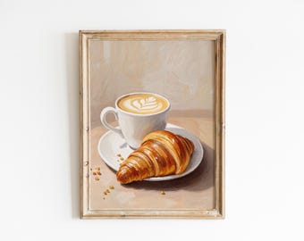 May include: A painting of a white cup of coffee with latte art and a croissant on a white plate. The painting is framed in a light wood frame.