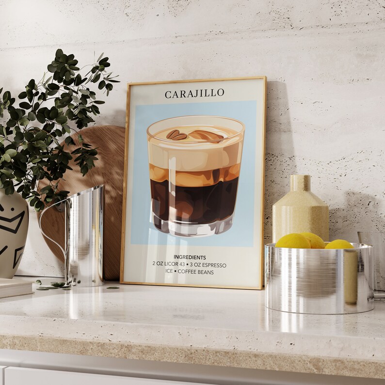 May include: A gold framed poster with a blue background and a glass of Carajillo. The poster has the text "Carajillo" at the top and "Ingredients: 2 oz Licor 43 + 3 oz Espresso, Ice + Coffee Beans" at the bottom.