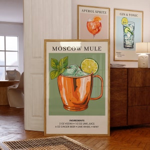 May include: A vintage-style poster with a green background featuring a Moscow Mule cocktail recipe. The poster shows a copper mug filled with ice, a lime wedge, and a sprig of mint. The text on the poster reads "Moscow Mule" and includes the ingredients: 2 oz vodka, 1/2 oz lime juice, 6 oz ginger beer, lime wheel, and mint.