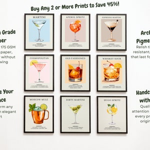 May include: Nine illustrated cocktail recipe prints in black frames on a white wall. Each print features a different cocktail with its name and ingredients listed below. The prints are available for purchase with a discount for buying two or more.