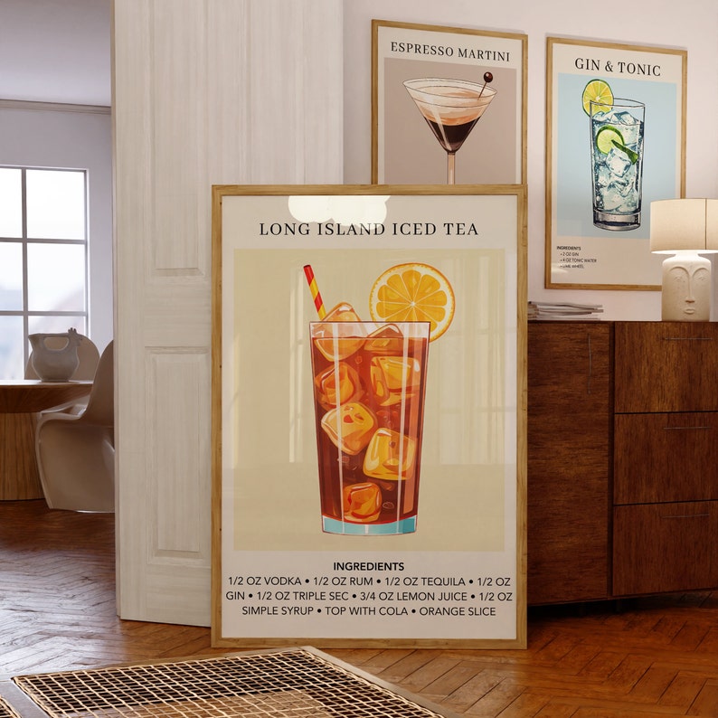 May include: A vintage-style poster with a colorful illustration of a Long Island Iced Tea cocktail. The poster has a light beige background with a brown wooden frame. The text on the poster reads "Long Island Iced Tea" and lists the ingredients for the cocktail.