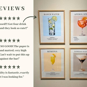 May include: Four framed cocktail recipe prints with illustrations of the drinks. The prints are in a light wood frame and have a white background. The drinks are Ranch Water, Aperol Spritz, Mimosa, and Espresso Martini.
