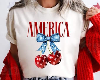 Camiseta Comfort Colors® America Cherry - Camiseta gráfica de 4 de julho, camiseta com laço patriótico, camisa de verão dos EUA, camiseta de inspiração vintage de 4 de julho