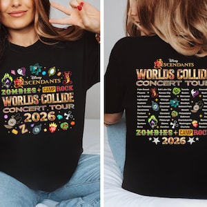 Puede incluir: Camiseta negra con el texto "Disney Descendants Worlds Collide Concert Tour 2026". La camiseta tiene gráficos coloridos y las palabras "Zombies + Camp Rock".