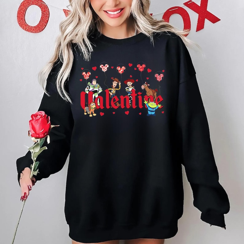 May include: Black sweatshirt with a red "Valentine" graphic featuring characters from the Toy Story franchise holding red heart balloons.
