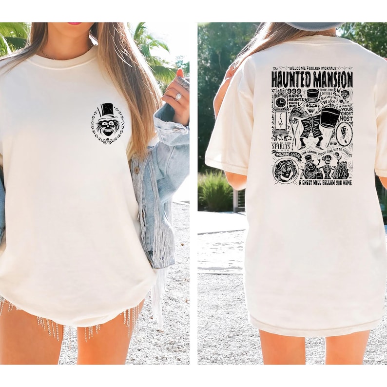 May include: White t-shirt with a black and white graphic of a ghost on the front and a black and white graphic of the Haunted Mansion on the back. The graphic on the back includes the text "Welcome Foolish Mortals" and "Haunted Mansion".