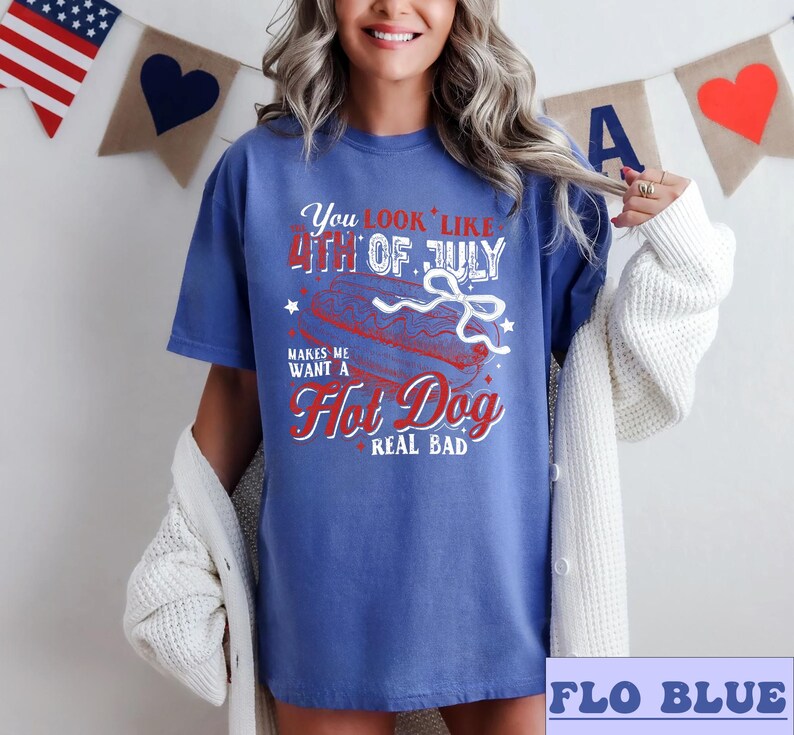 Pode incluir: Uma camiseta azul com um gr&aacute;fico vermelho, branco e azul que diz "You look like the 4th of July makes me want a Hot Dog real bad".