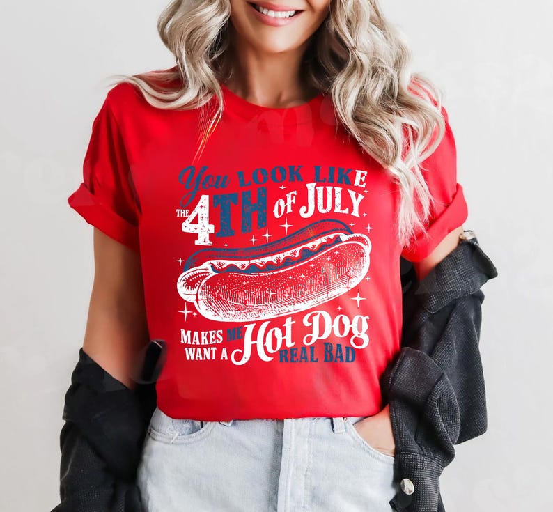 May include: Red t-shirt with a white graphic of a hot dog and the text "You look like the 4th of July. Makes me want a hot dog real bad."