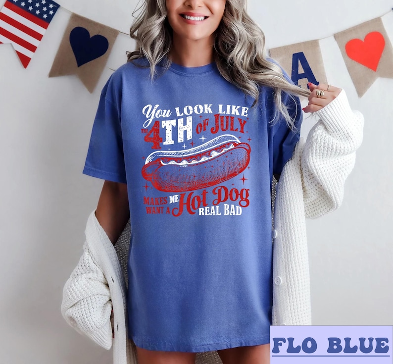 May include: A blue t-shirt with a red, white, and blue graphic that says "You look like the 4th of July. Makes me want a hot dog real bad."
