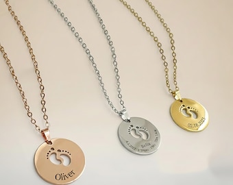 May include: Three necklaces with pendant charms. One is rose gold with the name "Oliver", one is silver with the name "Bella", and the third is gold with the date "02.18.2023". Each pendant features a cutout of baby footprints.