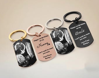 May include: Four metal dog tag keychains in gold, rose gold, silver, and black. Two feature engraved ultrasound images, while two are engraved with the text: Happy 1st Birthday as my Nanny/Uncle, I can't wait to meet you soon, Love From Bump x.