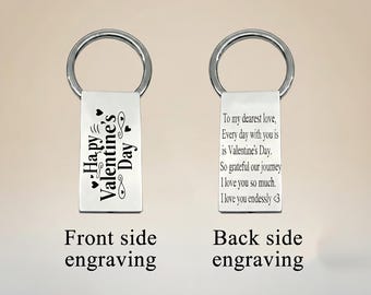 May include: Two silver rectangular keychains with a circular ring. One keychain has "Happy Valentine's Day" engraved on it. The other keychain has a loving message engraved on it. The image shows the front and back side engraving.