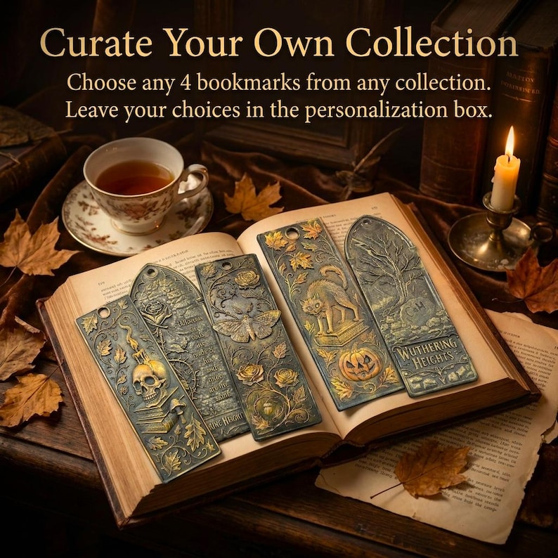 May include: An open book displays five antique-style metal bookmarks with intricate designs. The bookmarks feature a skull, a butterfly, a cat with a pumpkin, and other gothic-themed elements. The text "Curate Your Own Collection" is at the top.