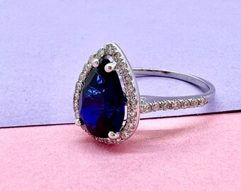 Handcrafted 14K Yellow Gold Ring showcasing lab grown Blue sapphire and Sparkling natural Diamond halo and Accents"